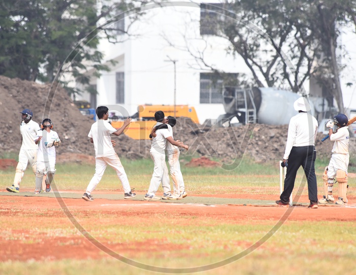 School kids celebrating for a fall of wicket during cricket match