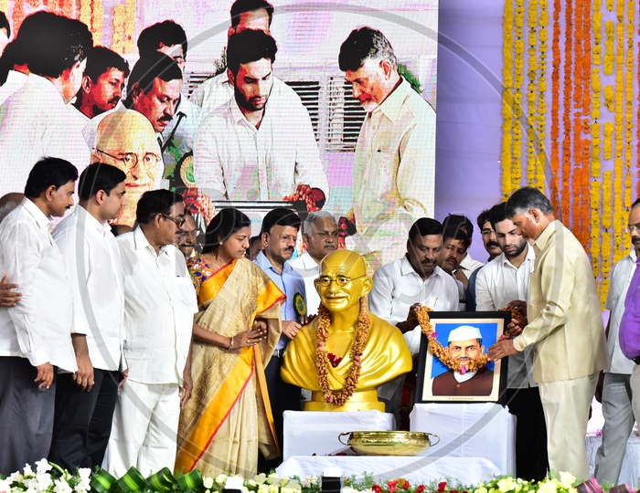 AP Chief Minister Chandra Babu Naidu garlanding the photo during the launch of Swachh Andhra Mission