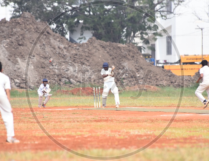 School kids playing cricket