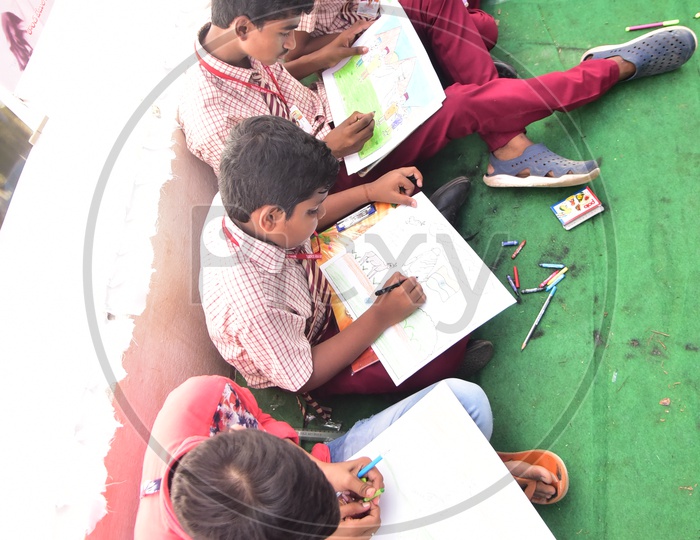 School kids drawing sketches during a drawing competition