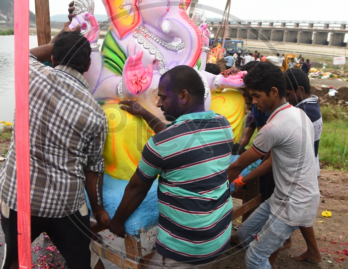 Men carrying the Ganesha Idol onto the Crane
