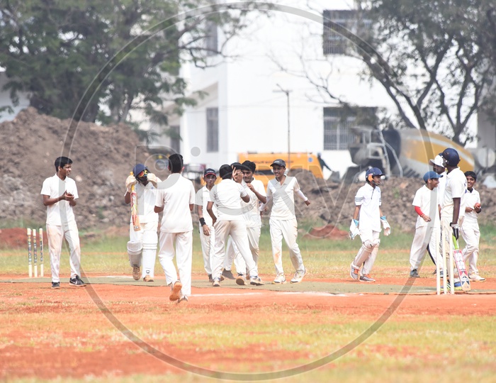 School kids celebrating for a fall of wicket during cricket match
