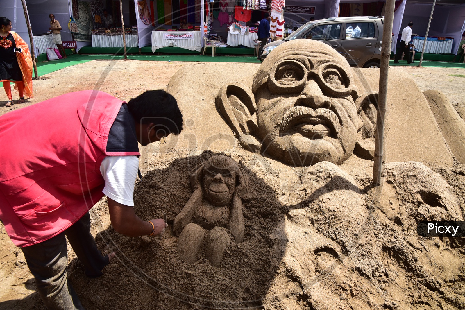Sand Artist sculpting Gandhi Sculpture
