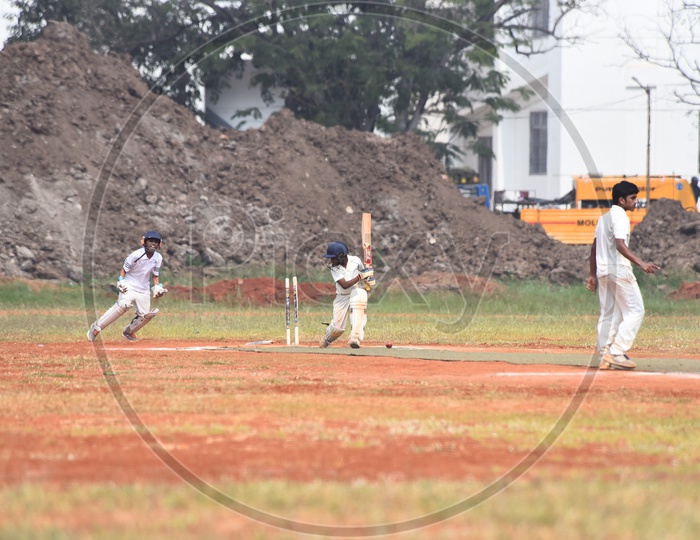 School kids playing cricket in the ground
