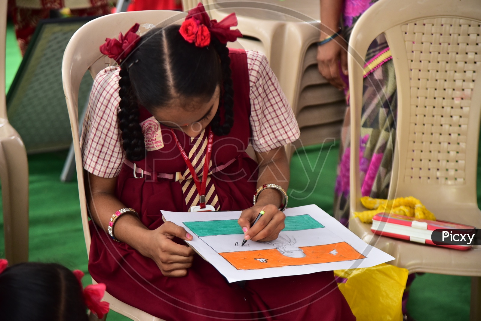 A left handed school girl drawing a sketch during a competition