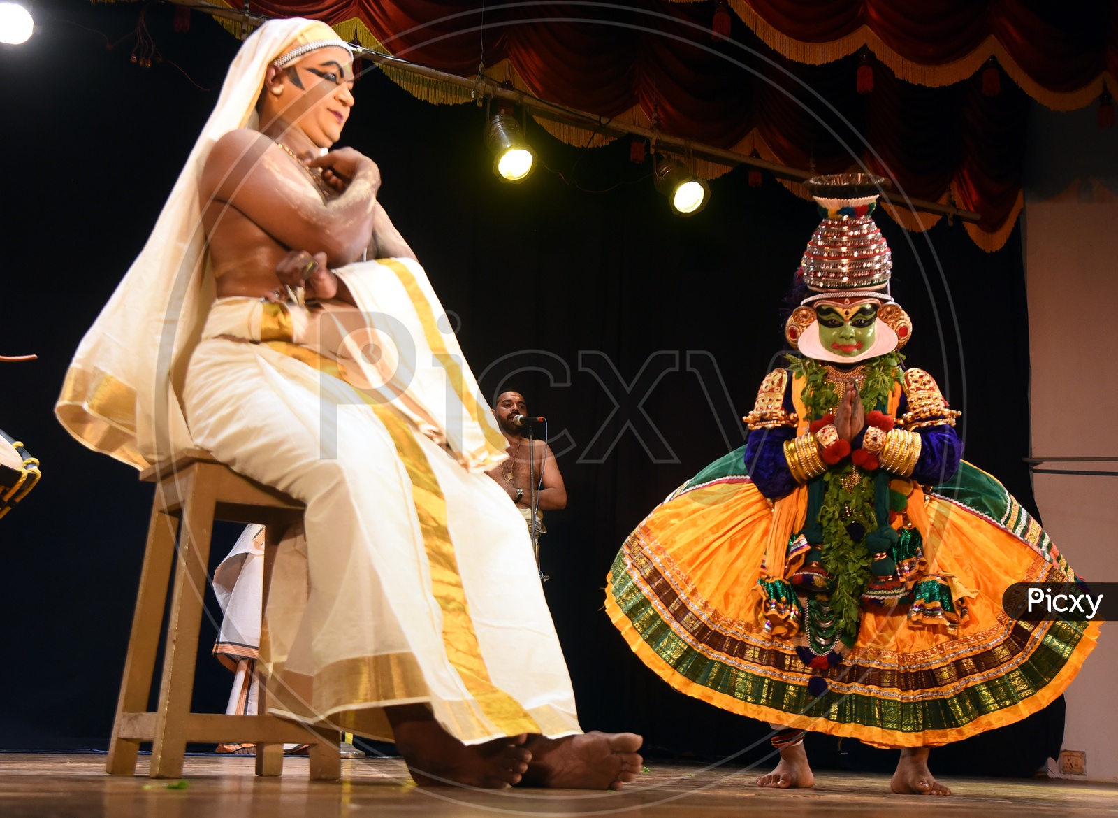 Artists performing Indian Classical Dance form Kathakali on stage