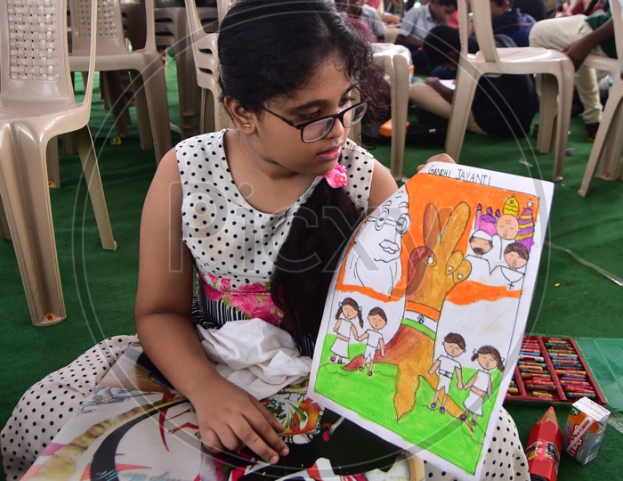 A school girl showing her drawing