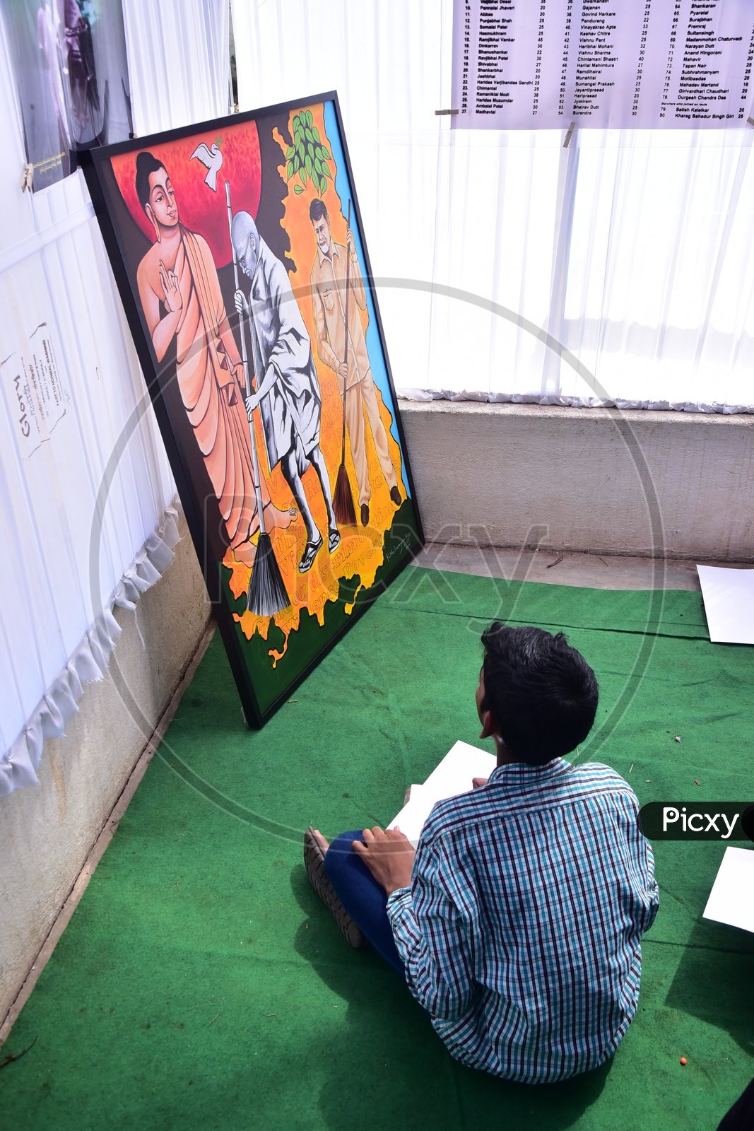 School kid drawing a sketch during a competition