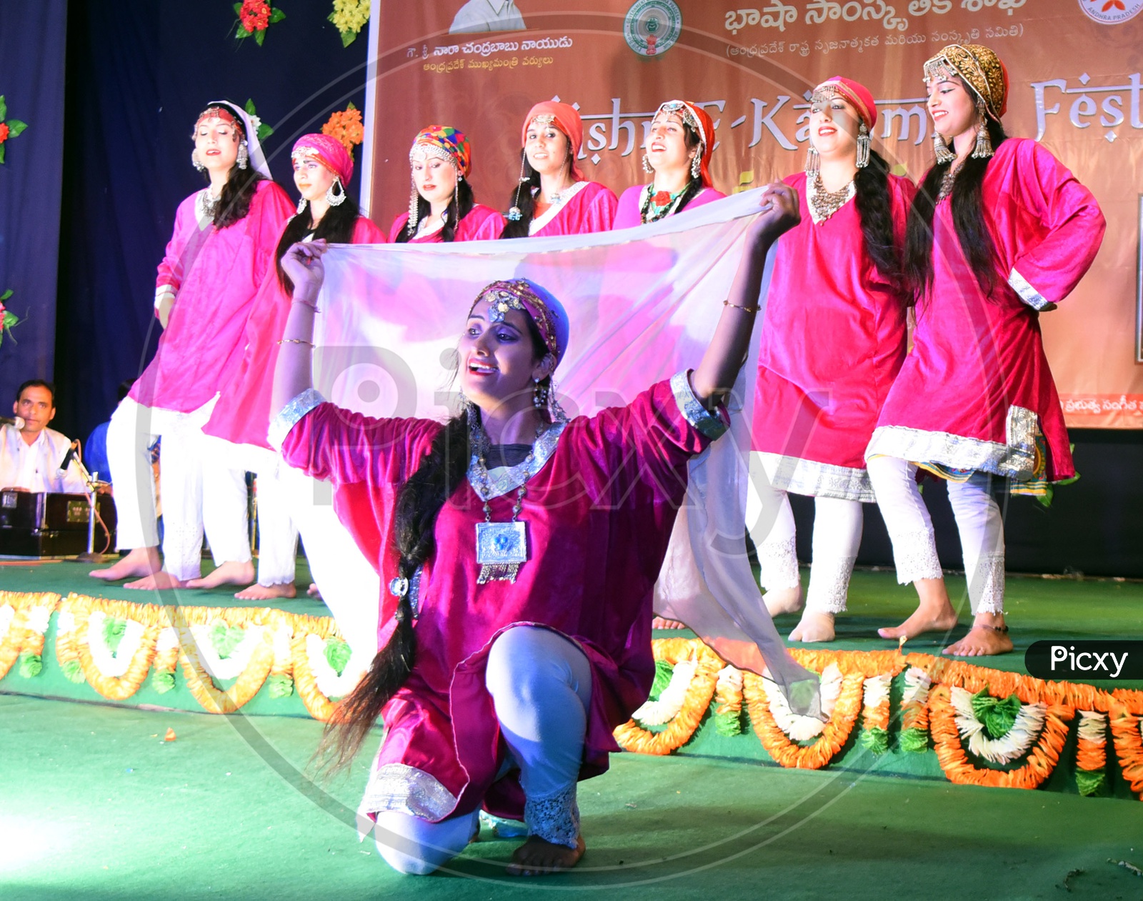 Artists performing Dogri dance on stage