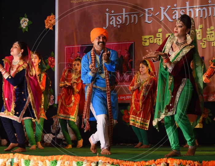 Artists performing Bhand Jashan dance on stage