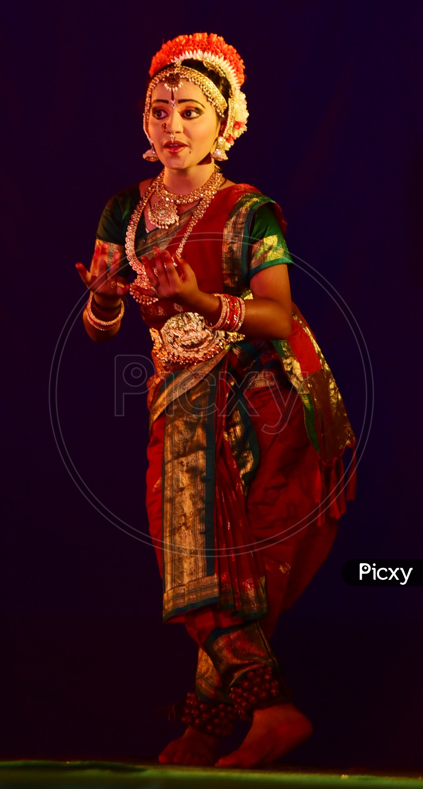 bharatanatyam dancer performing on stage