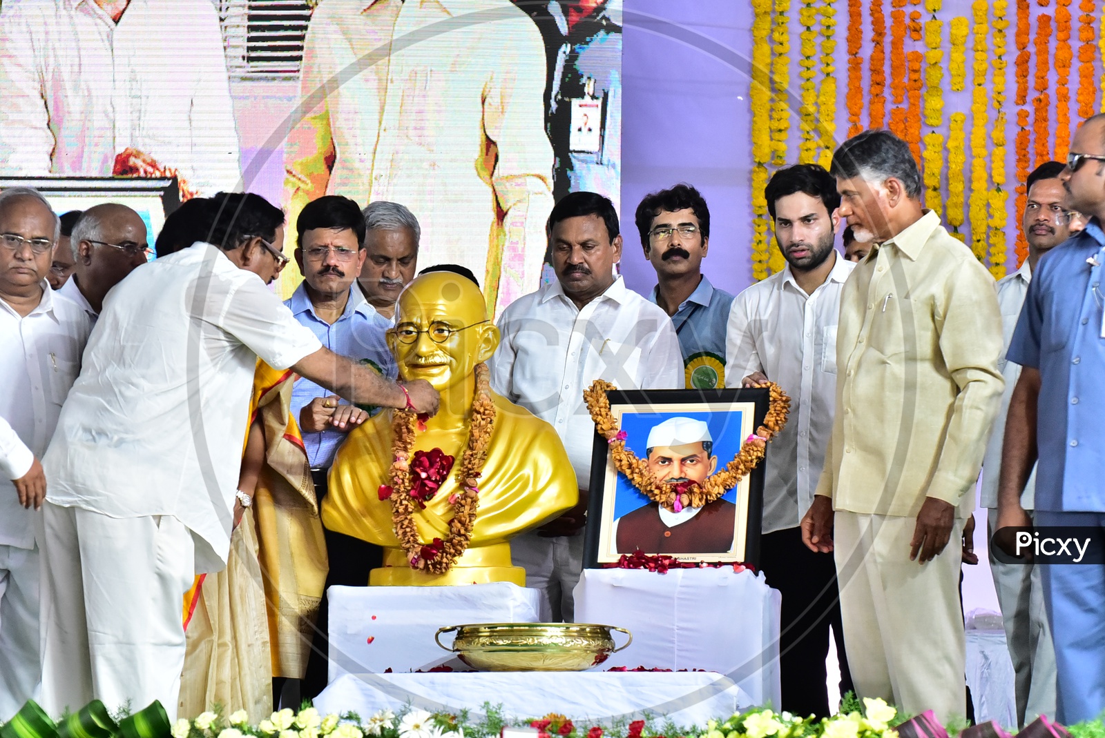 AP Chief Minister Chandra Babu Naidu garlanding the photo during the launch of Swachh Andhra Mission