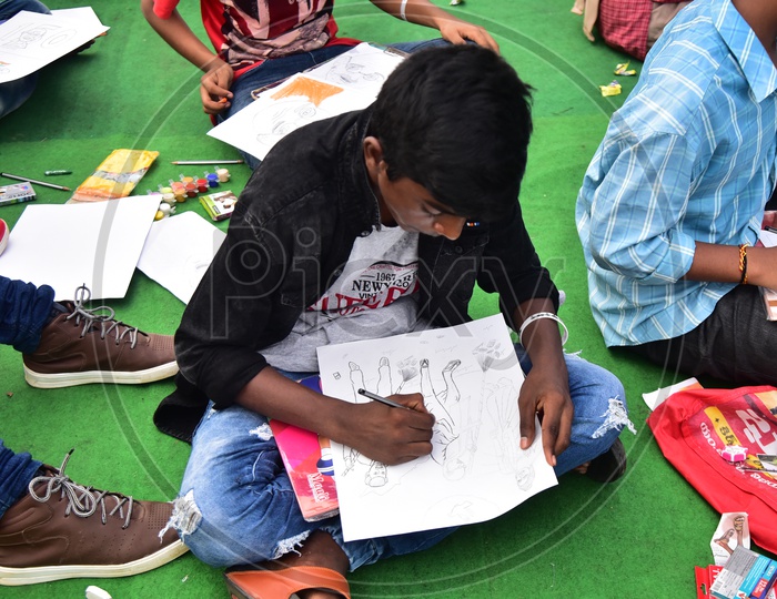 A school boy drawing a sketch during competition