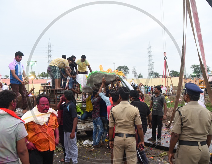 Police men looking after Men carrying the Ganesha Idol onto the Crane