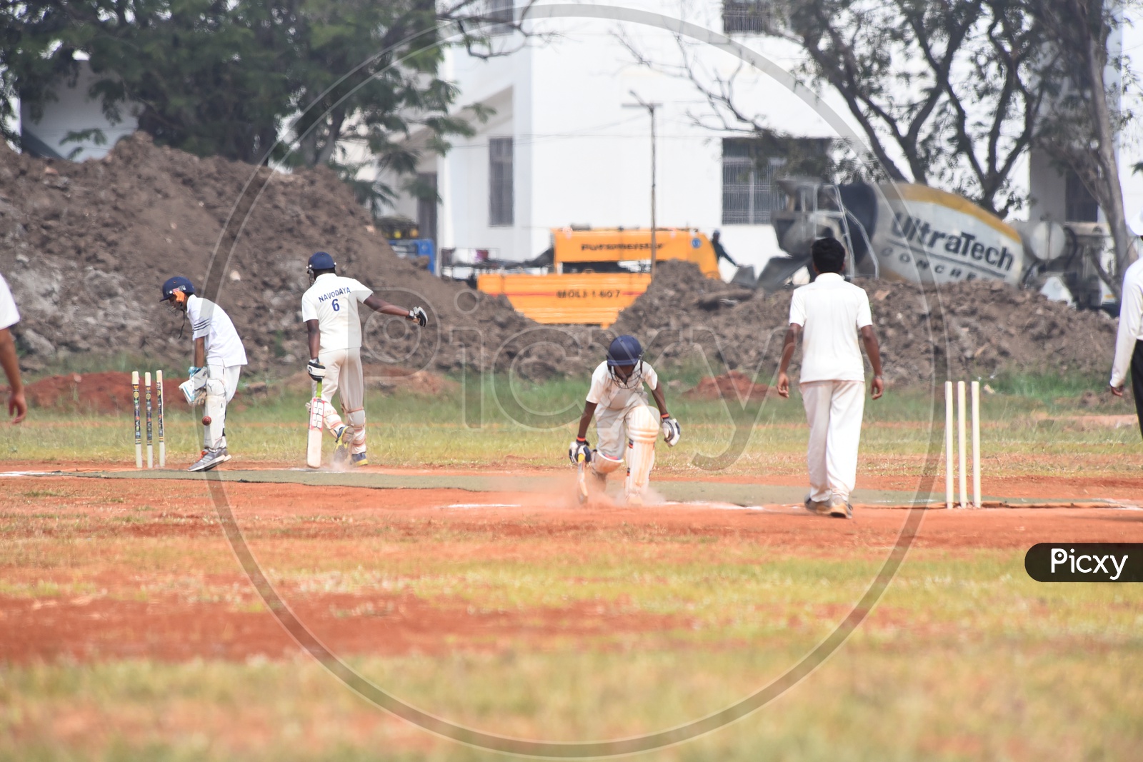 School kids playing cricket in the ground