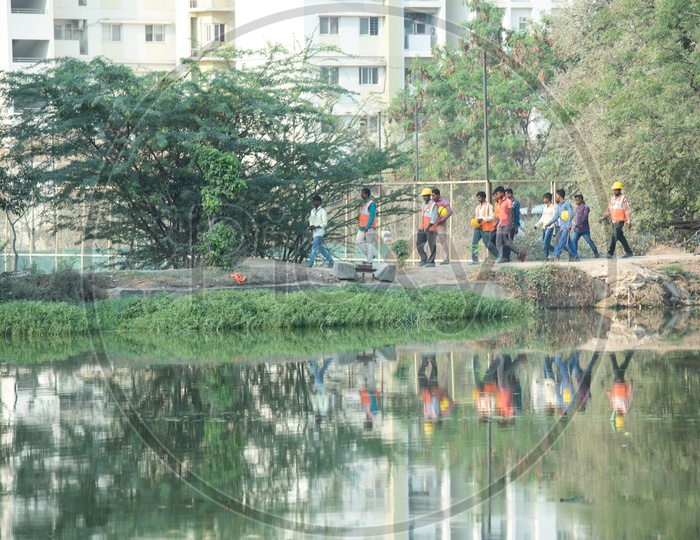 Construction workers walking on the road near Wipro lake