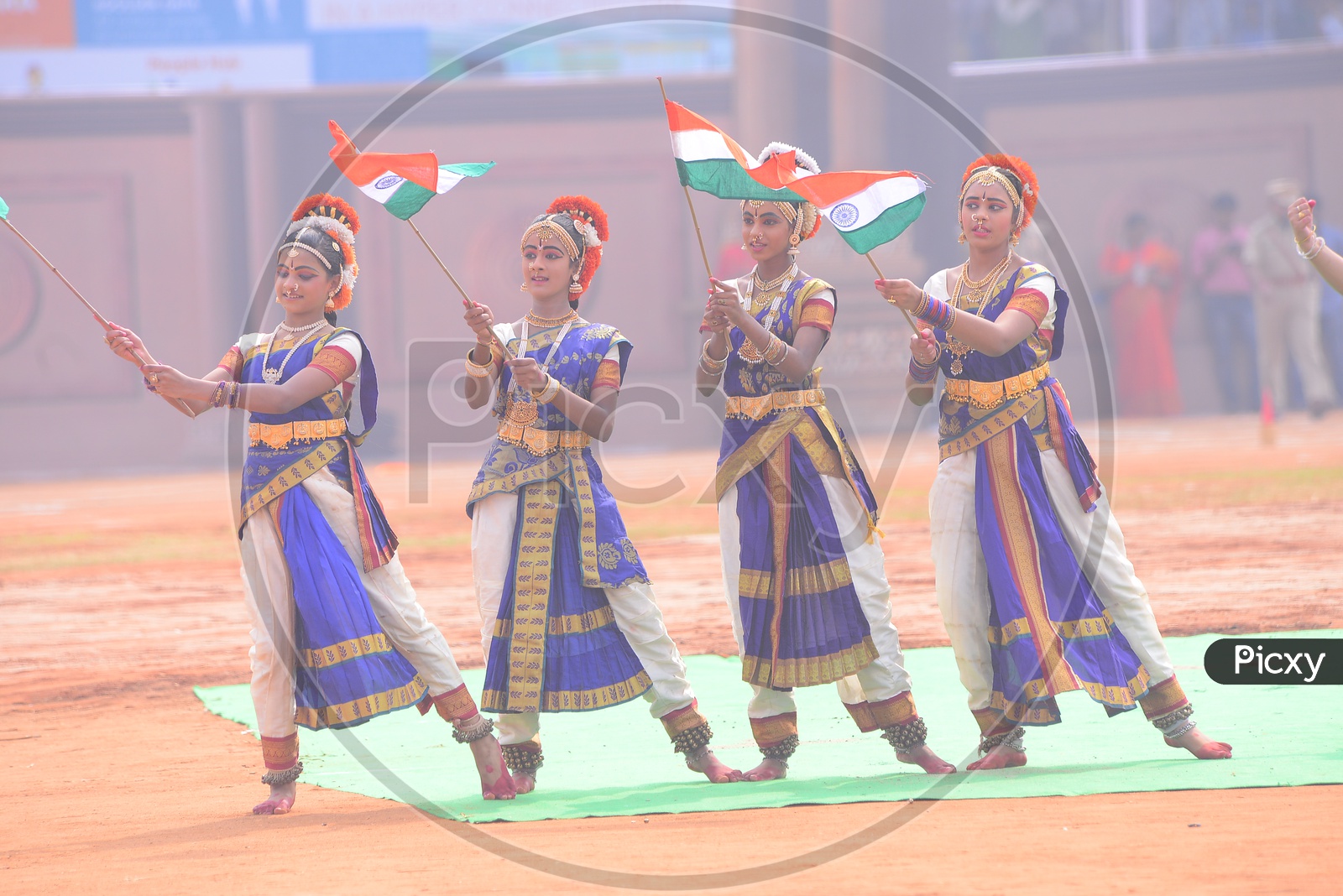 School Students In Classical Dancers Attire Holding Indian National Flags