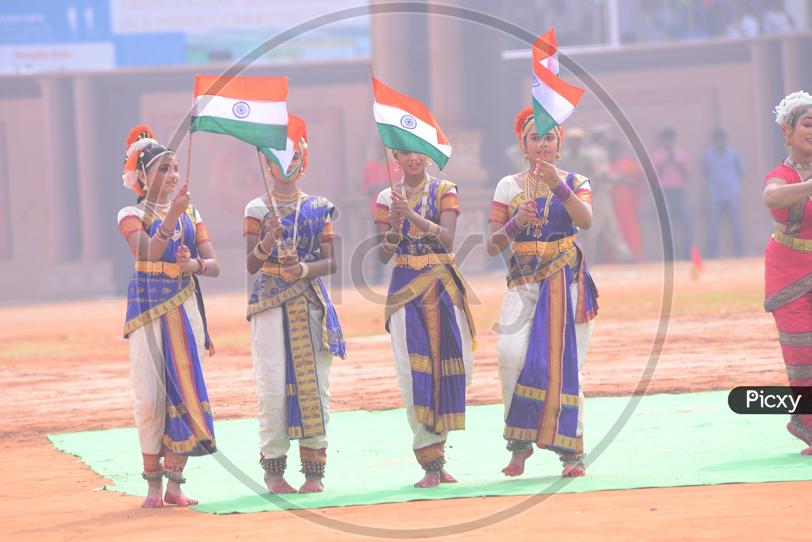 Girls In Traditional Attire Holding Indian National Flags