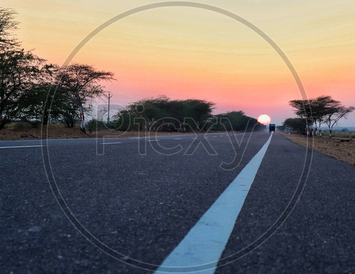 Road with sunset in middle of dessert