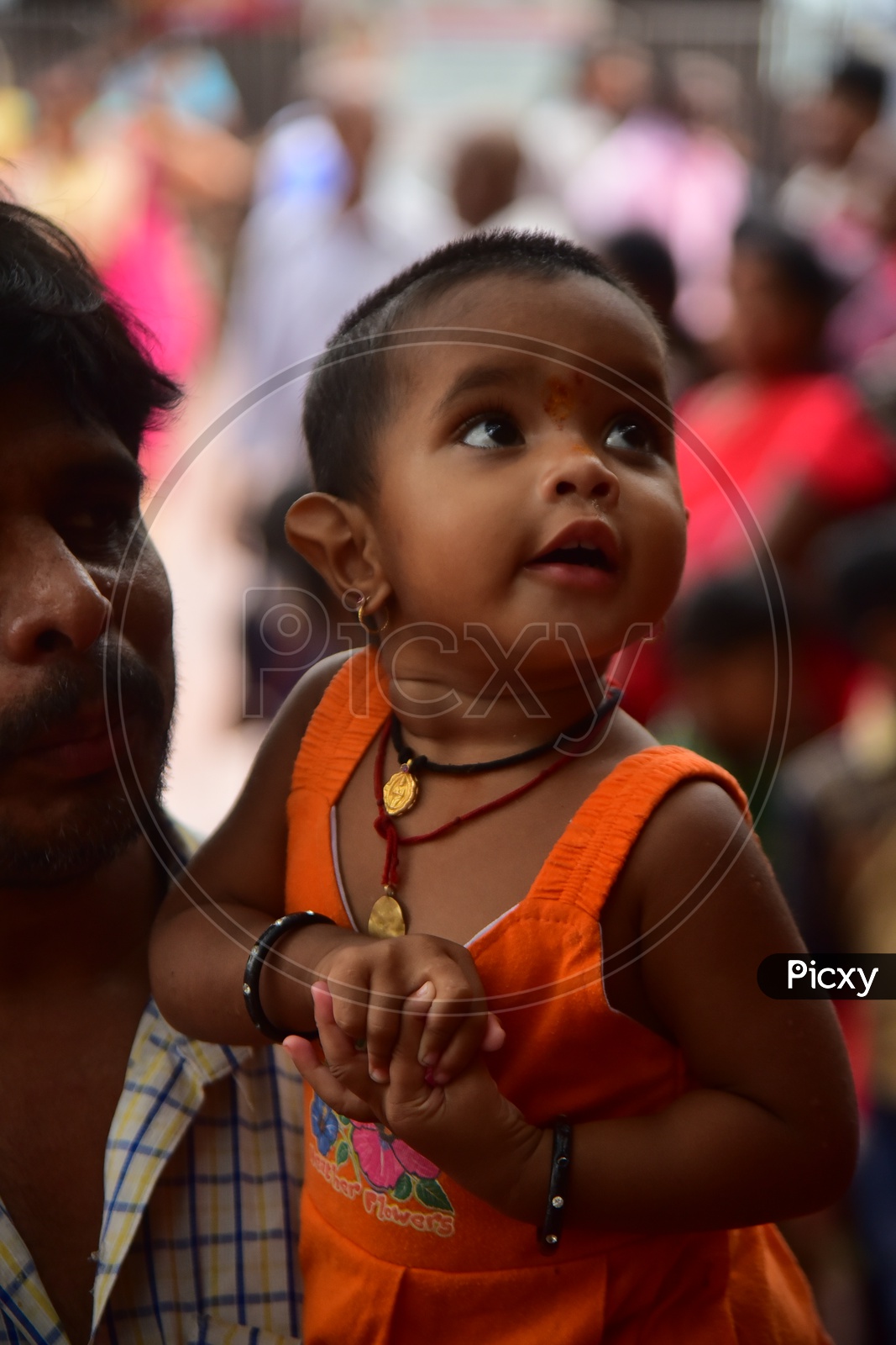 A Father Along With His Daughter In Queue Line For  Darshan