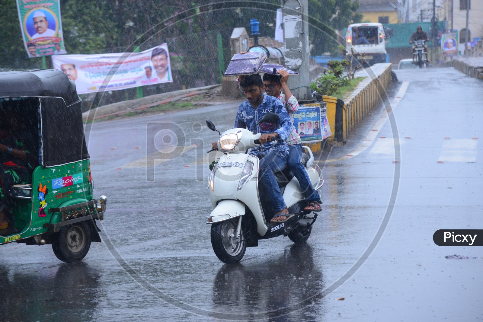 Biker on the road while its raining