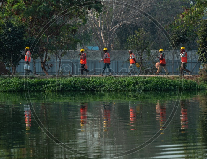 Construction workers walking on the road near wipro lake