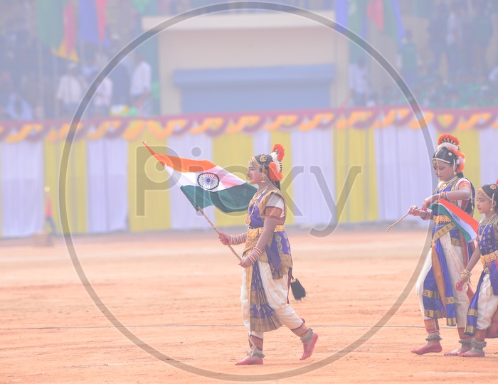 Girls In Traditional Attire Holding Indian National Flags