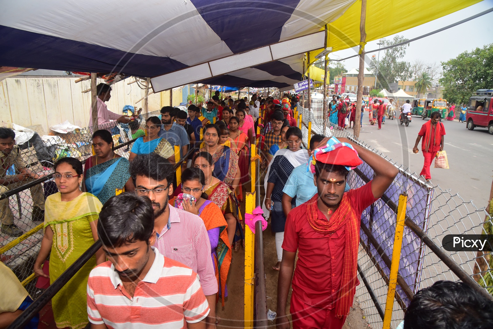 Devotees Carrying Mudupulu By wearing Bhavani Mala in Queue Lines