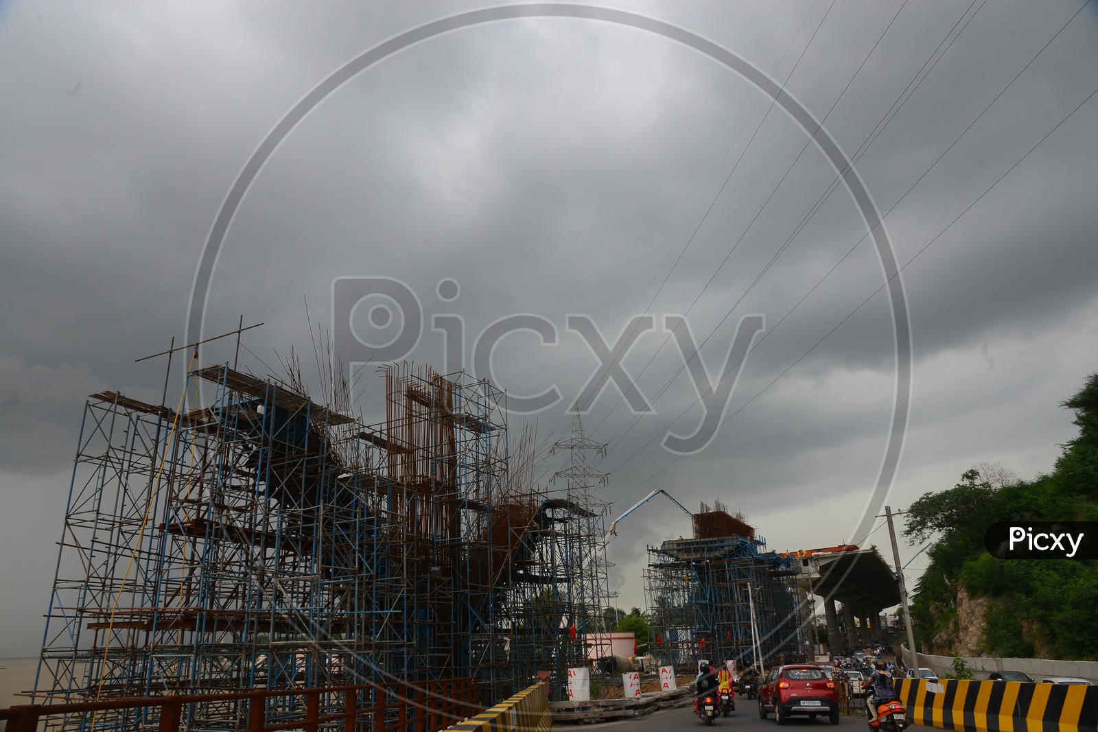 Traffic on the road beside Metro construction works in Vijayawada