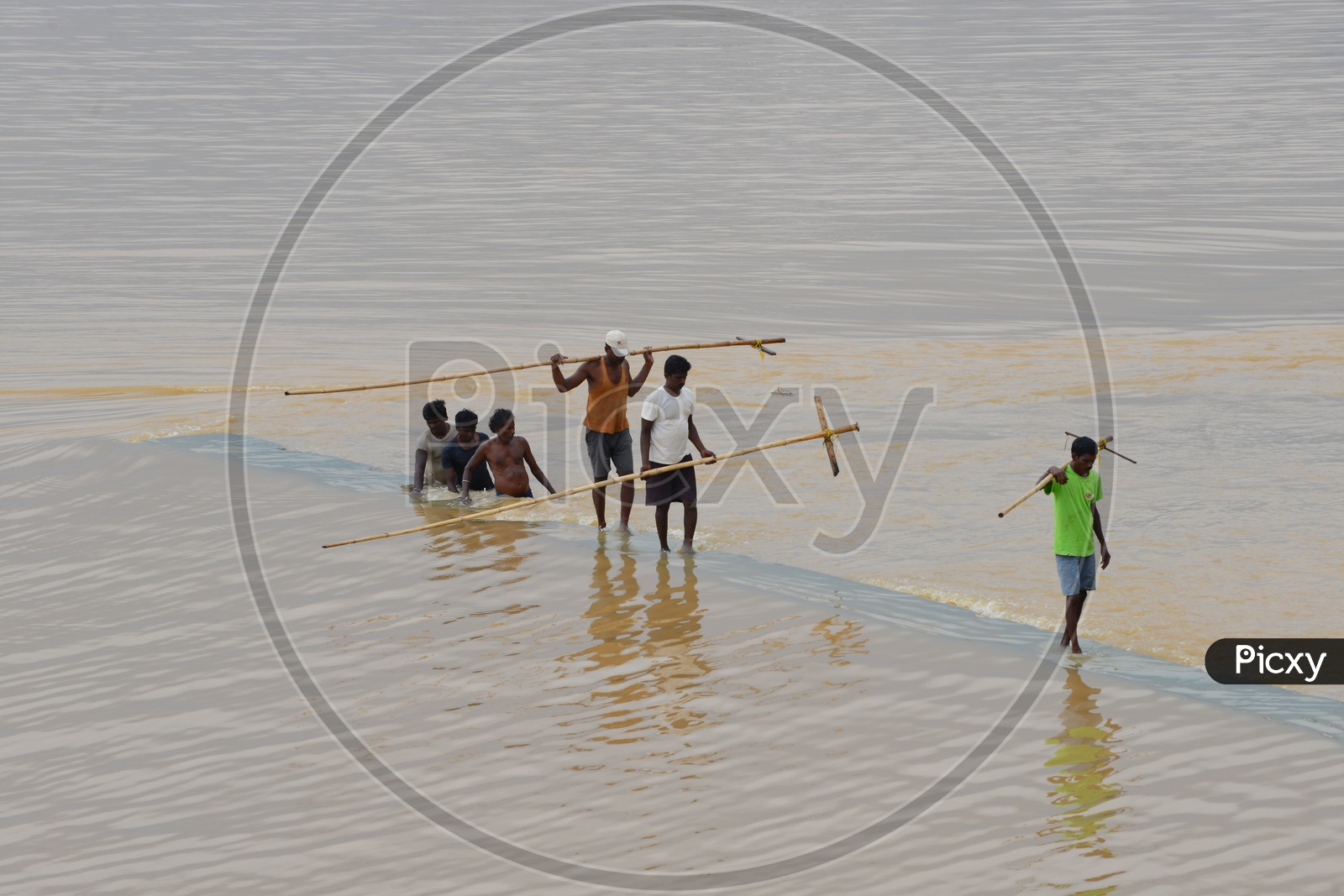 Men with wooden surf fishing rod in Krishna river
