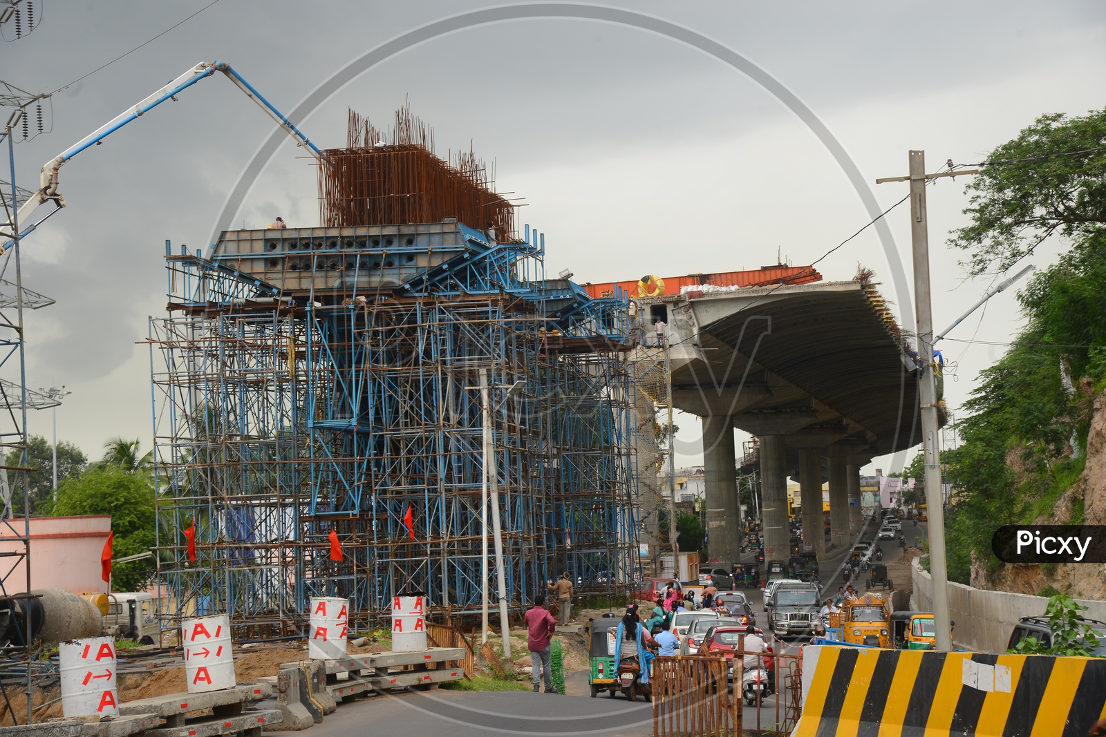 Traffic on the road beside flyover construction works in Vijayawada
