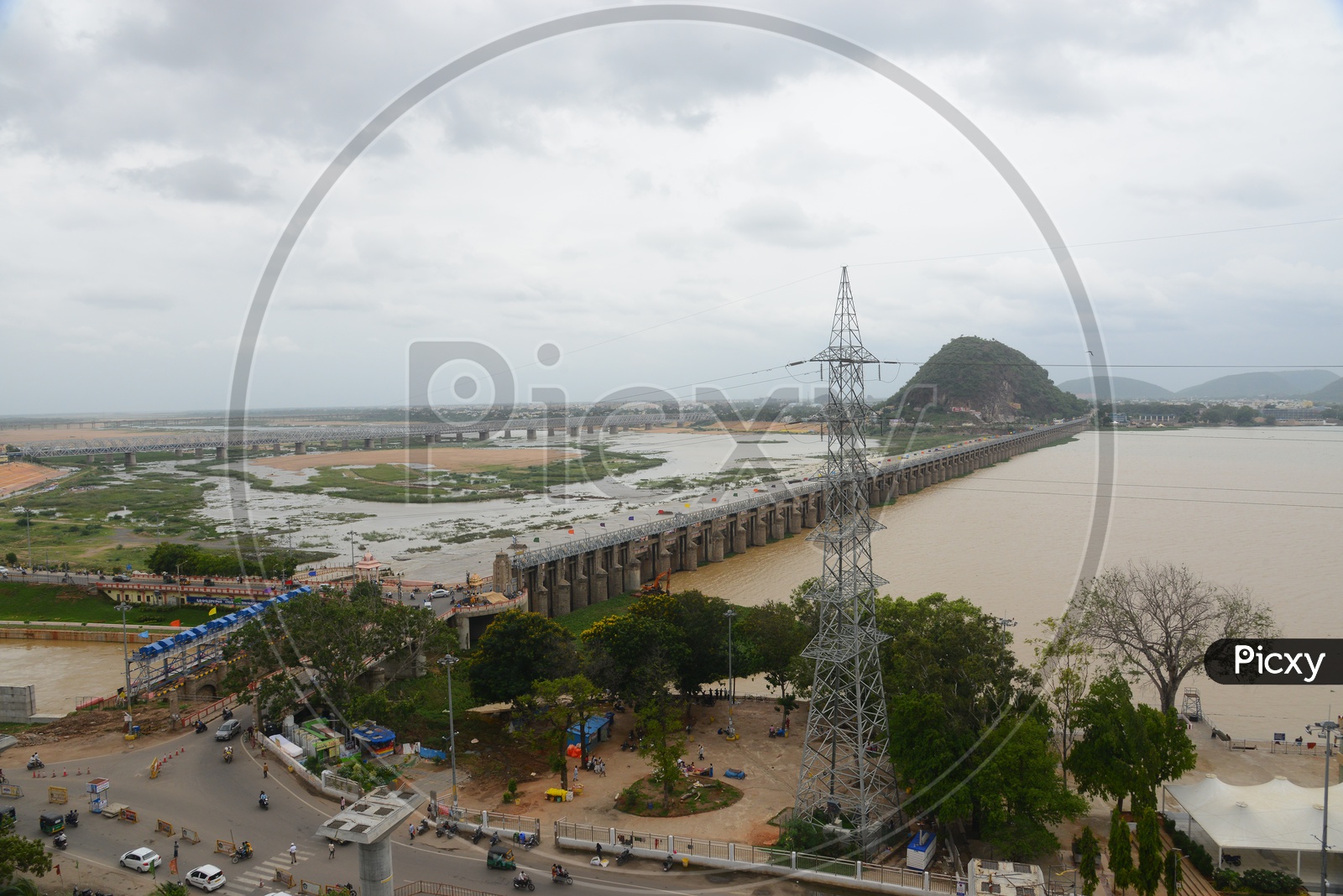 Ariel view of the praksam barrage over Krishna river and traffic in Vijayawada .Gates opened/lifted.