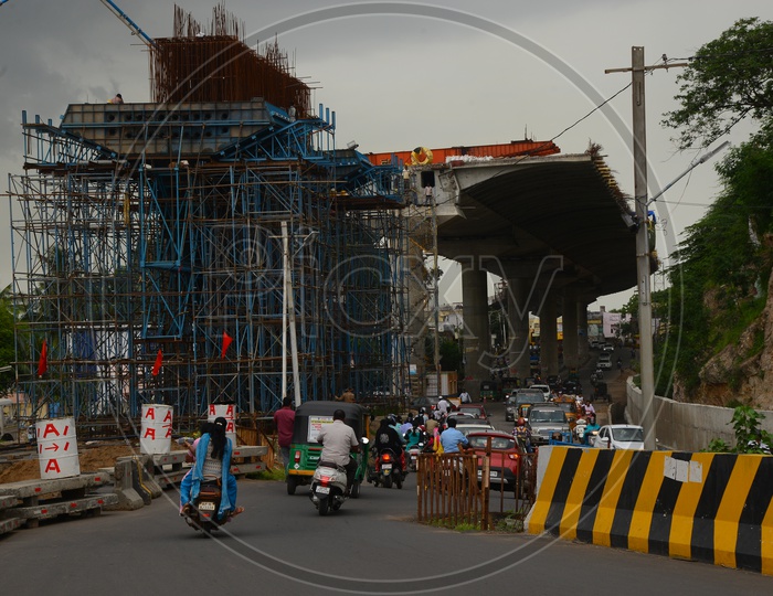 Traffic on the road beside flyover construction works in Vijayawada