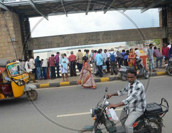 People and traffic on Praksam barrage over Krishna river in Vijayawada as gates lifted