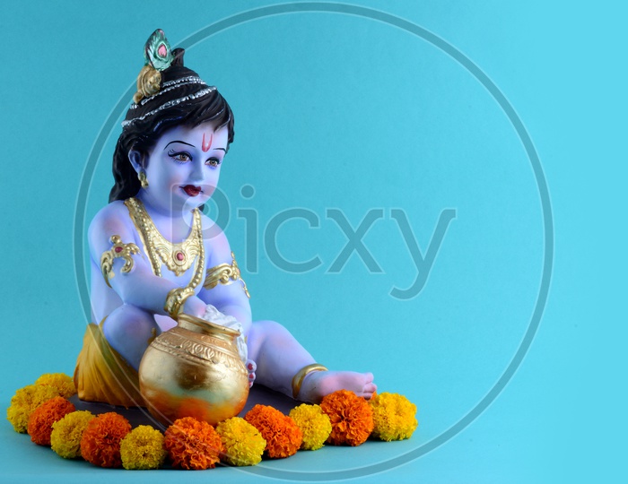 Little Krishna Idol on light blue background