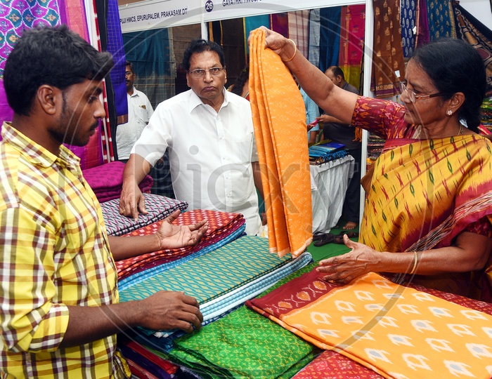 Indian Old Woman checking out the sarees