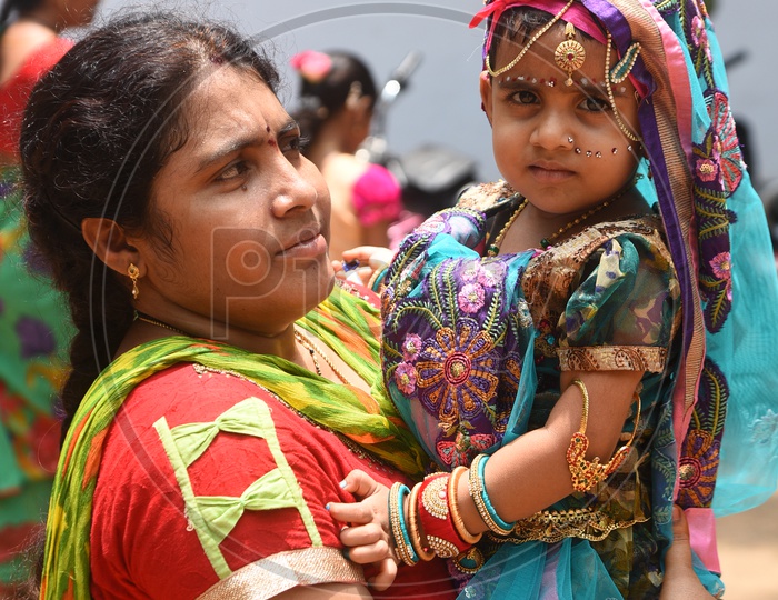 Mom & A little girl dressed as Gopika with a decorated earthen pot
