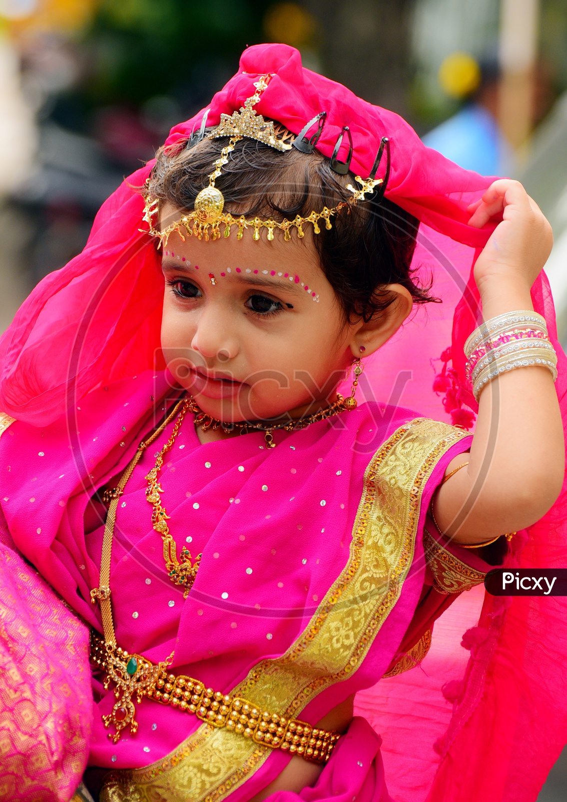 A Girl child dressed up in a saree