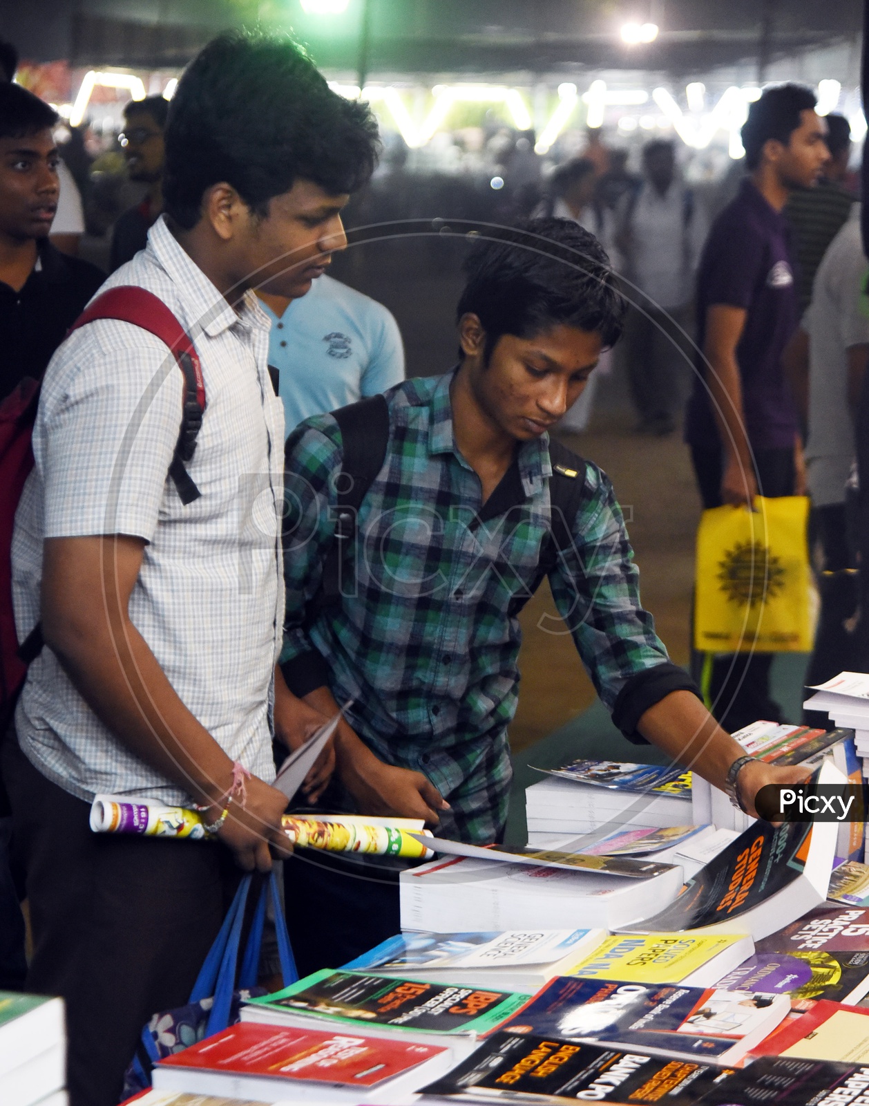 Students checking out the books at a stall