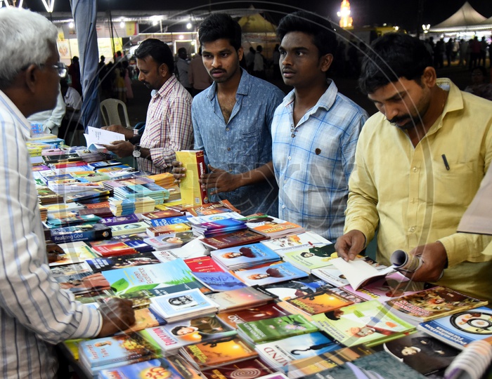 Men buying books at the stall
