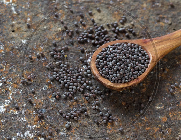 Mustard seeds in a wooden spoon