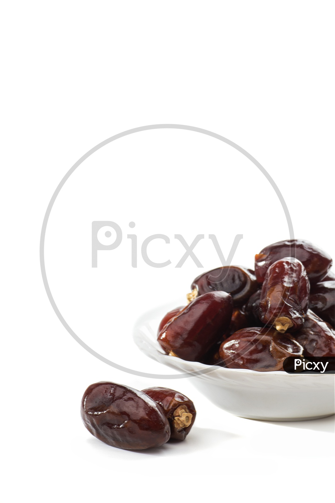 Dates in a white bowl isolated on a white background