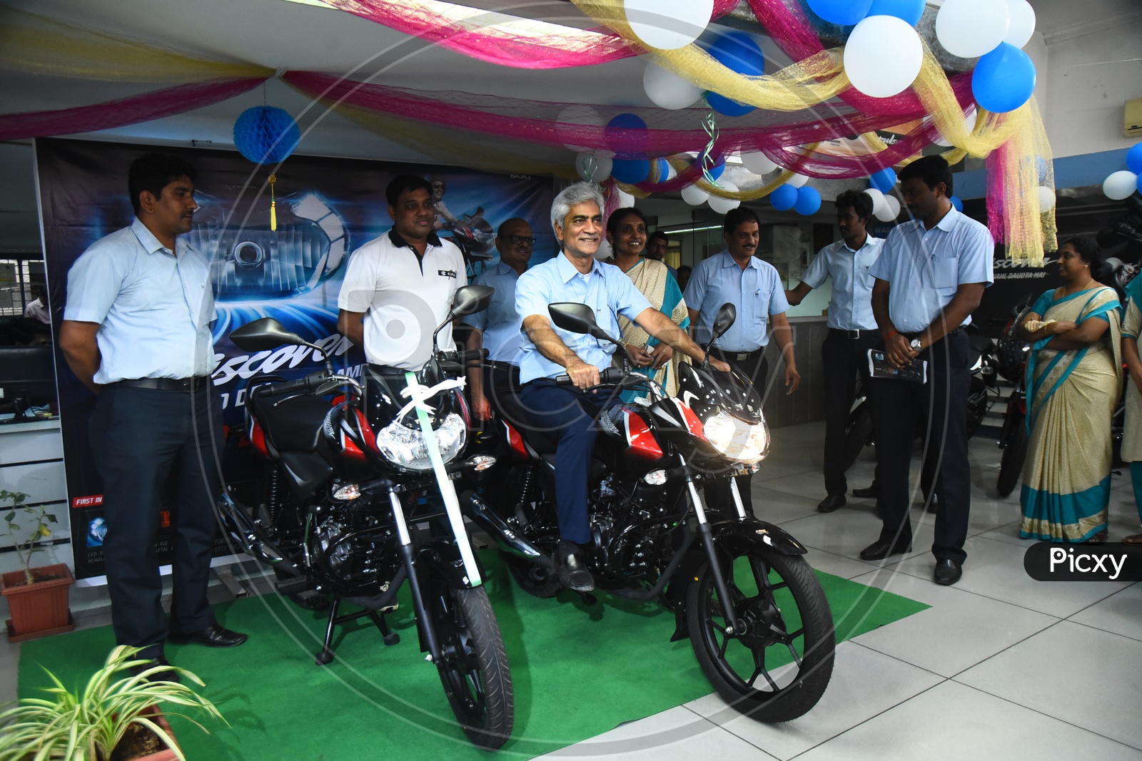 Staff checking the new Bajaj Discover motorcycle