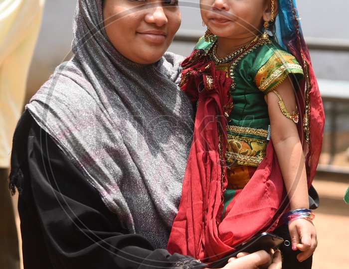 Muslim Mother With  her child who is in traditional attire