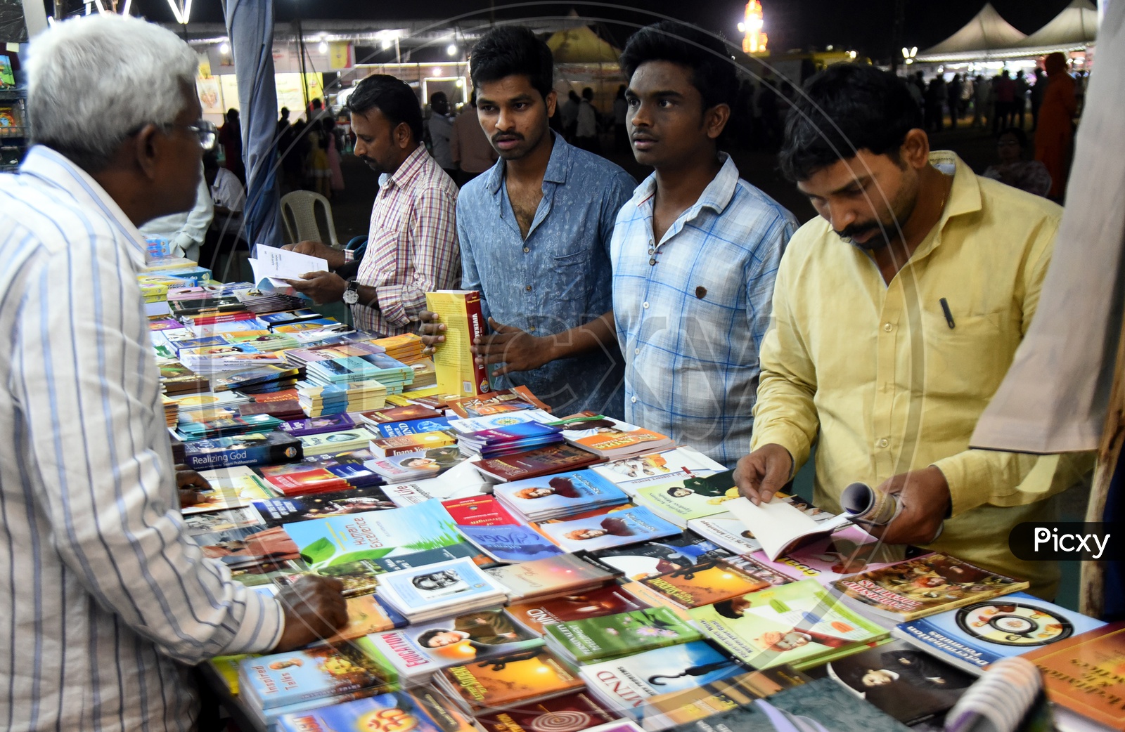 Men buying books at the stall