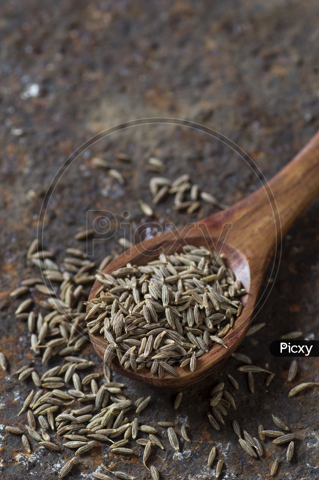 Cumin seeds in a wooden spoon
