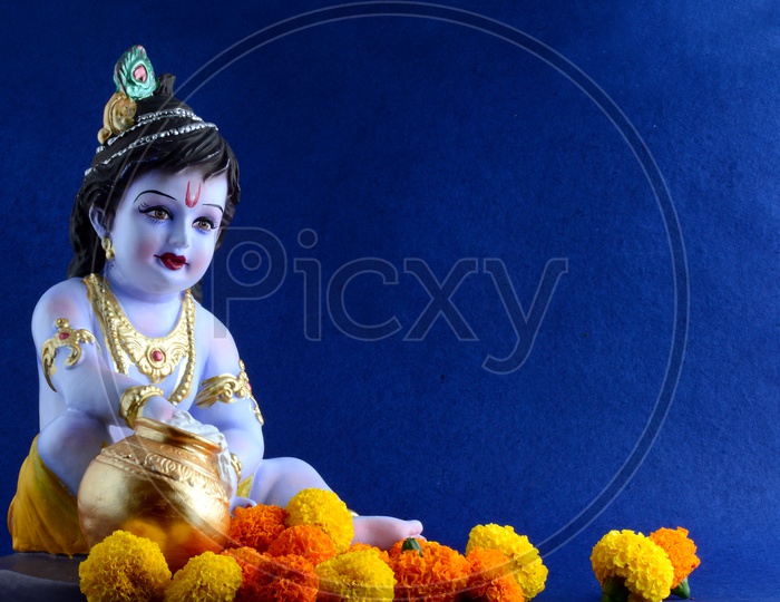 Little Krishna Idol on dark blue background