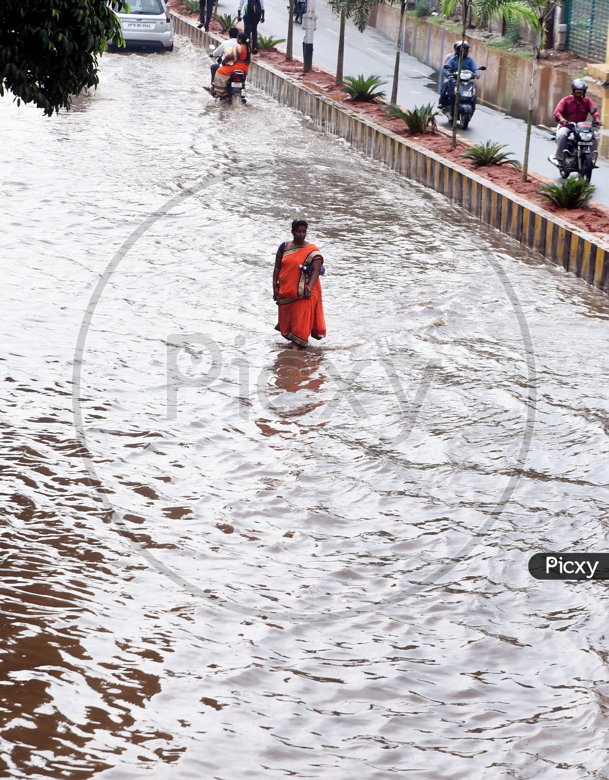 A woman walking on the flooded road