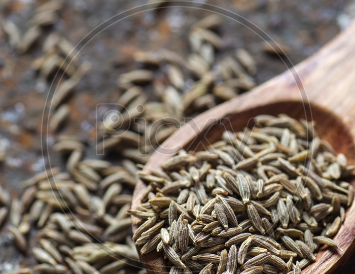 Cumin seeds in a wooden spoon