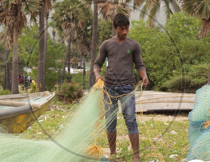 fisherman detangling the fishing net